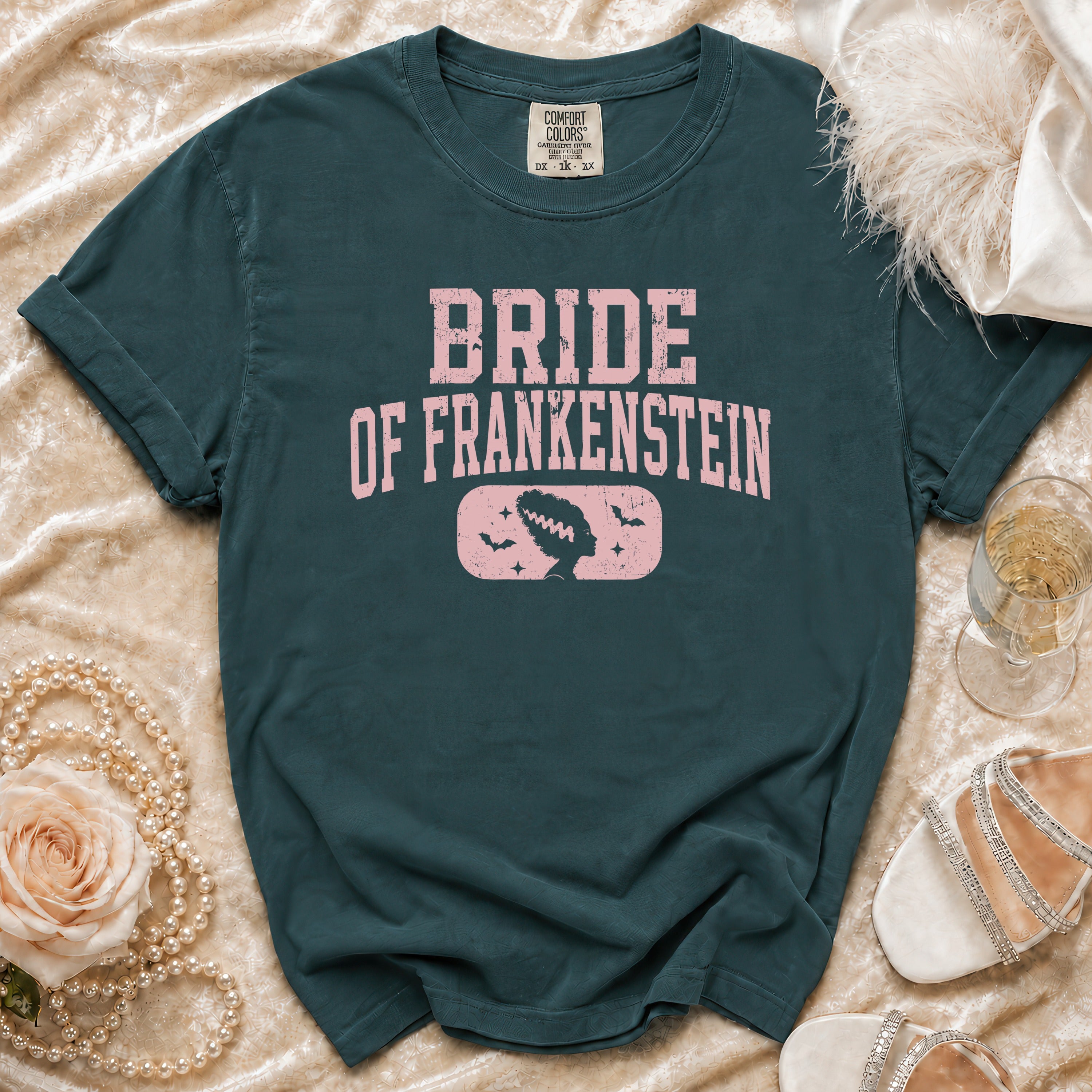 Bride of Frankenstein graphic t-shirt with vintage details on a teal shirt.