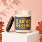 Lit candle in glass jar with lid off, text "WARNING: THE HONEYMOON NEVER ENDS"