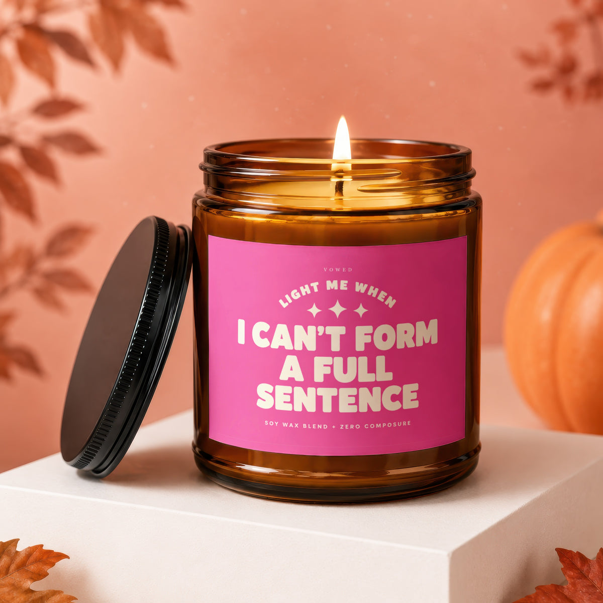 Amber jar candle with pink label reading "I can't form a full sentence".