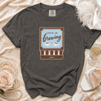 Dark gray t-shirt with "Love is Brewing" graphic and two coffee cups.