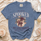 Blue t-shirt with "Mother of the Bride SPOOKED BUT STILL BOOKED" graphic.