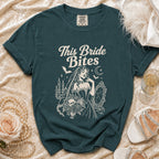 Teal t-shirt with "This Bride Bites" text and vampire bride graphic.