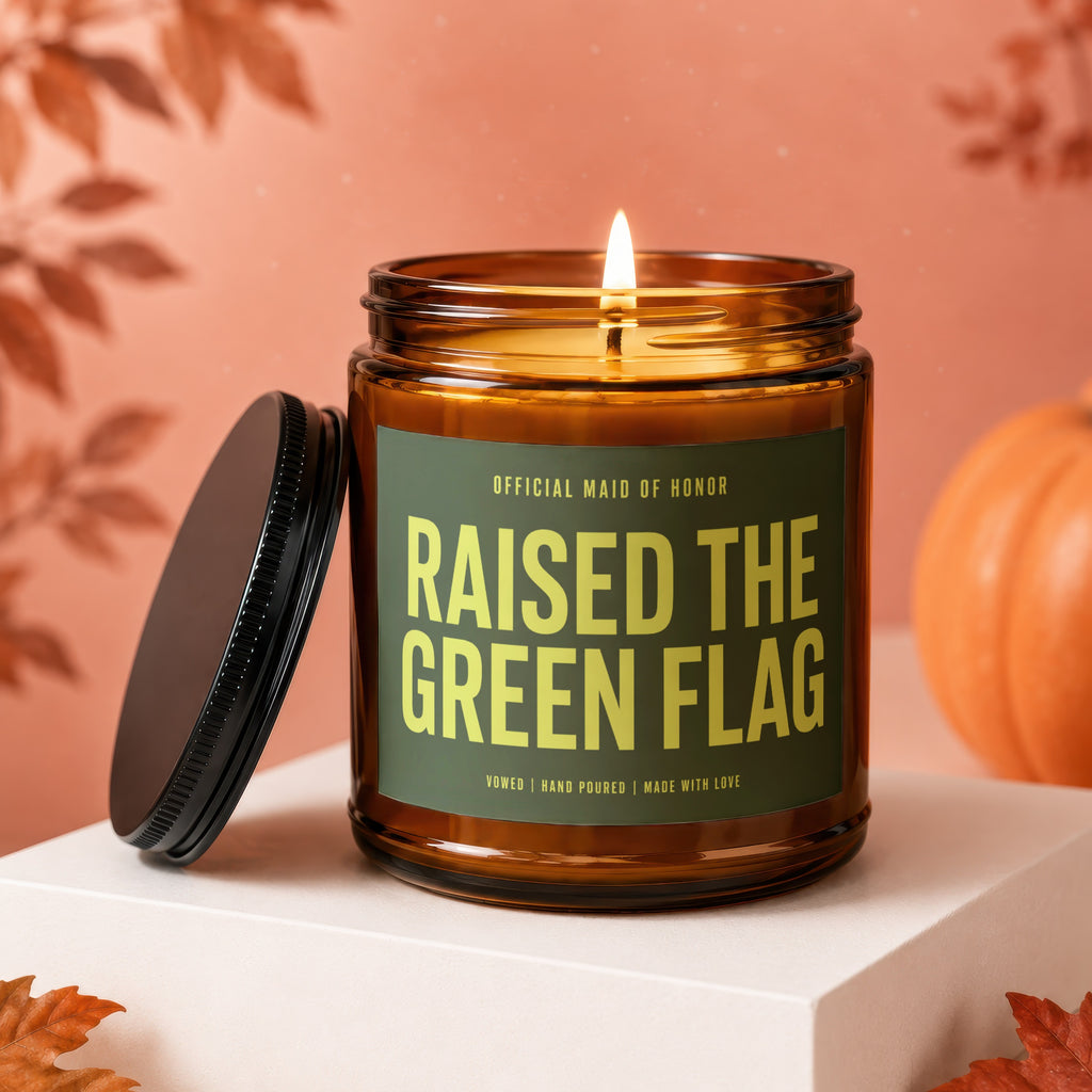 Amber candle with green label reading "Raised the Green Flag" for Maid of Honor.