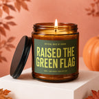 Amber candle with green label reading "Raised the Green Flag" for Maid of Honor.