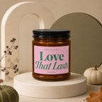 Candle with pink label reading "Smells Like Love That Lasts Vowed."