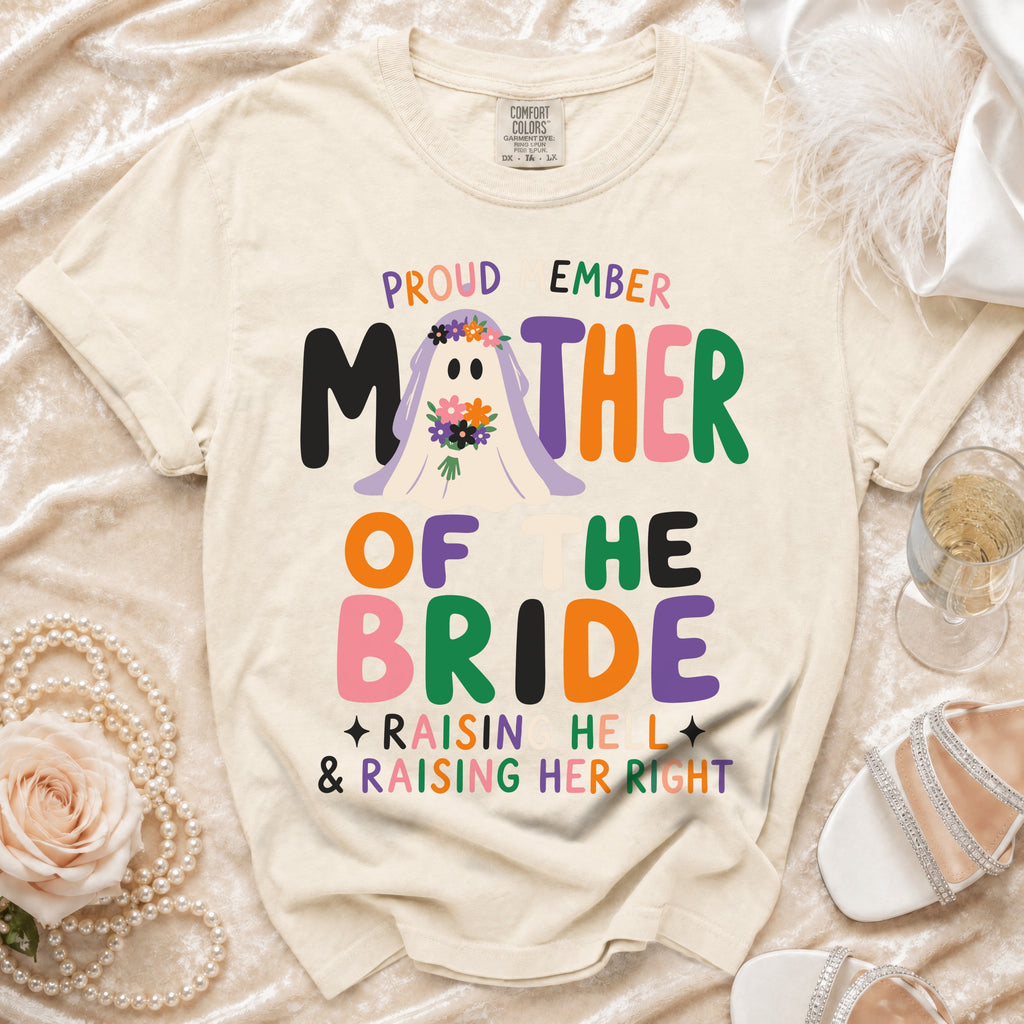 Cream t-shirt with "Proud Member Mother of the Bride" graphic.