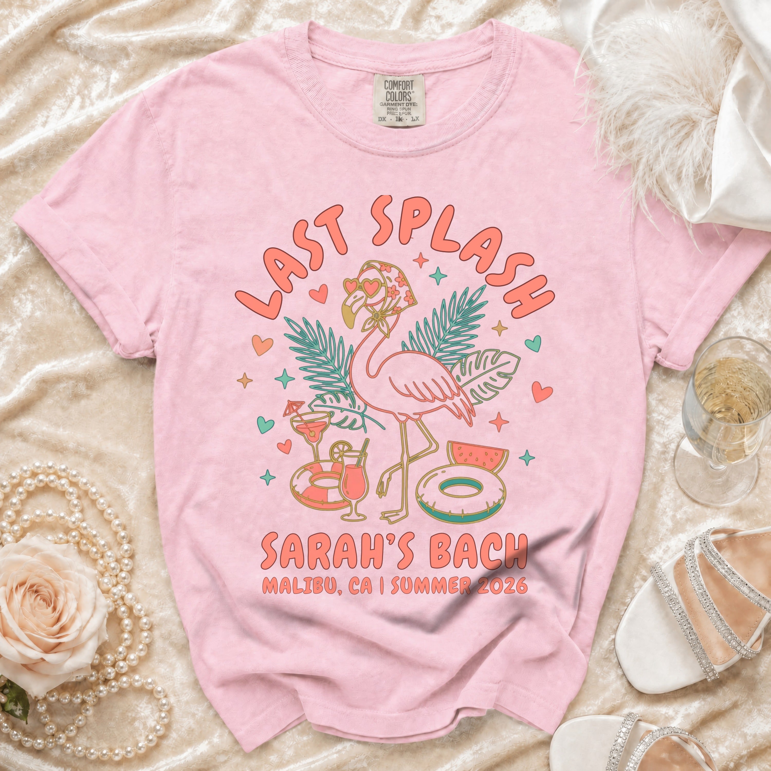 Pink t-shirt with "Last Splash Sarah's Bach Malibu, CA I Summer 2026" text and flamingo graphic.