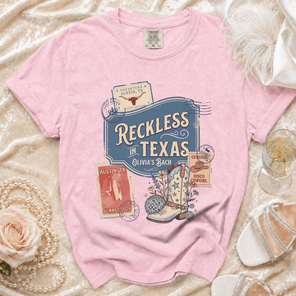 Pink t-shirt with "Reckless in Texas" and disco cowboy boot graphic.