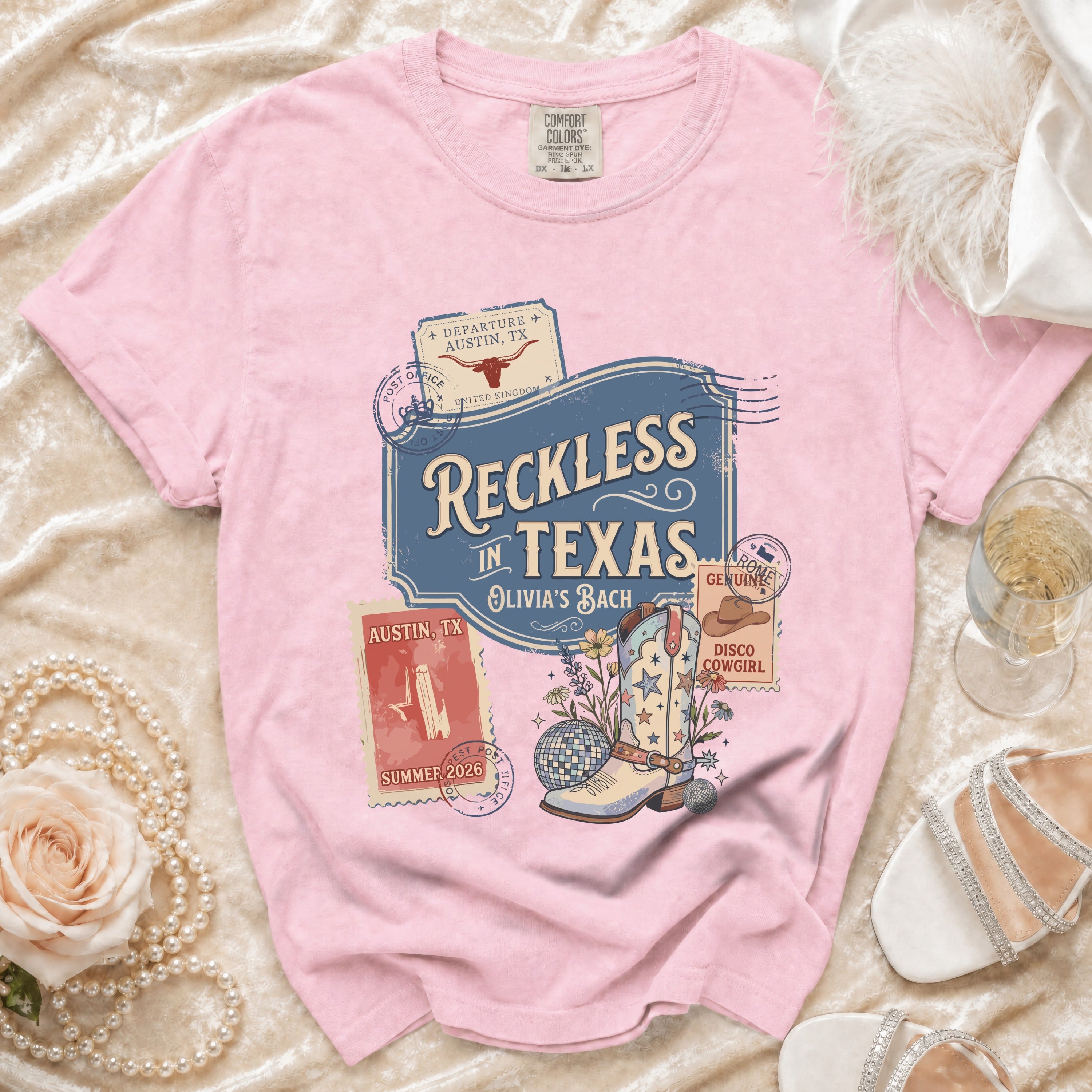 Pink t-shirt with "Reckless in Texas" and disco cowboy boot graphic.