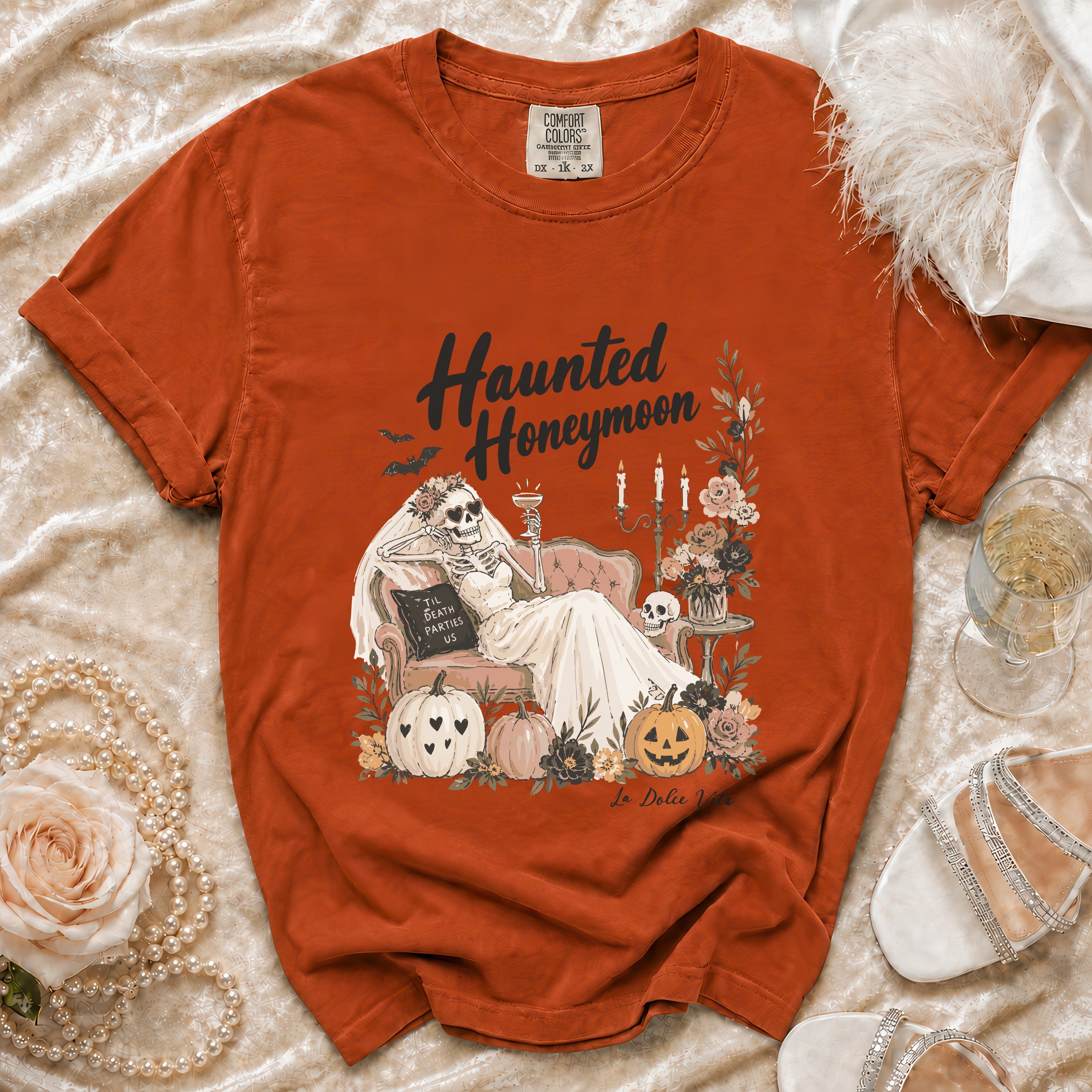 Orange Comfort Colors t-shirt with "Haunted Honeymoon" graphic of skeleton bride and pumpkins.