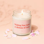 Candle with pink label reading "Wishing You Luck a Lifetime of Love."