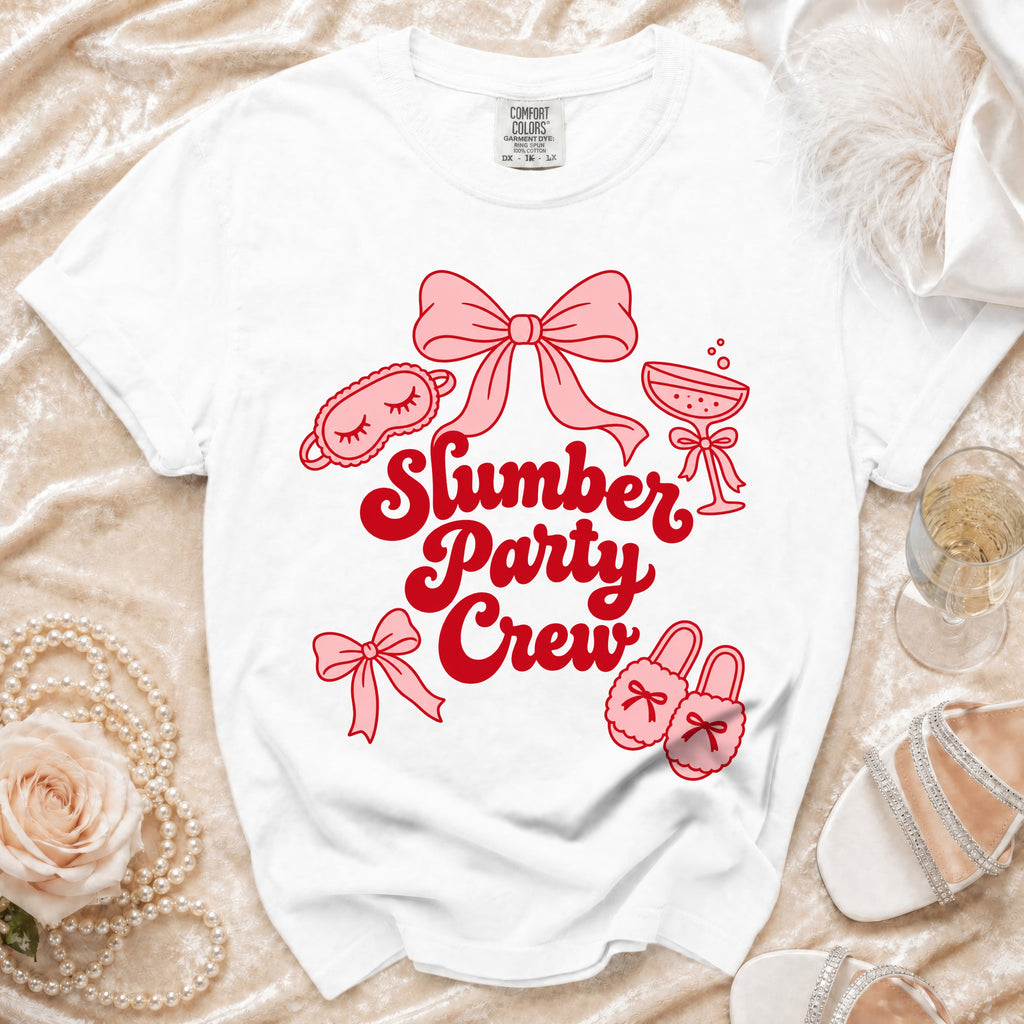 White t-shirt with "Slumber Party Crew" text and slumber party graphics.
