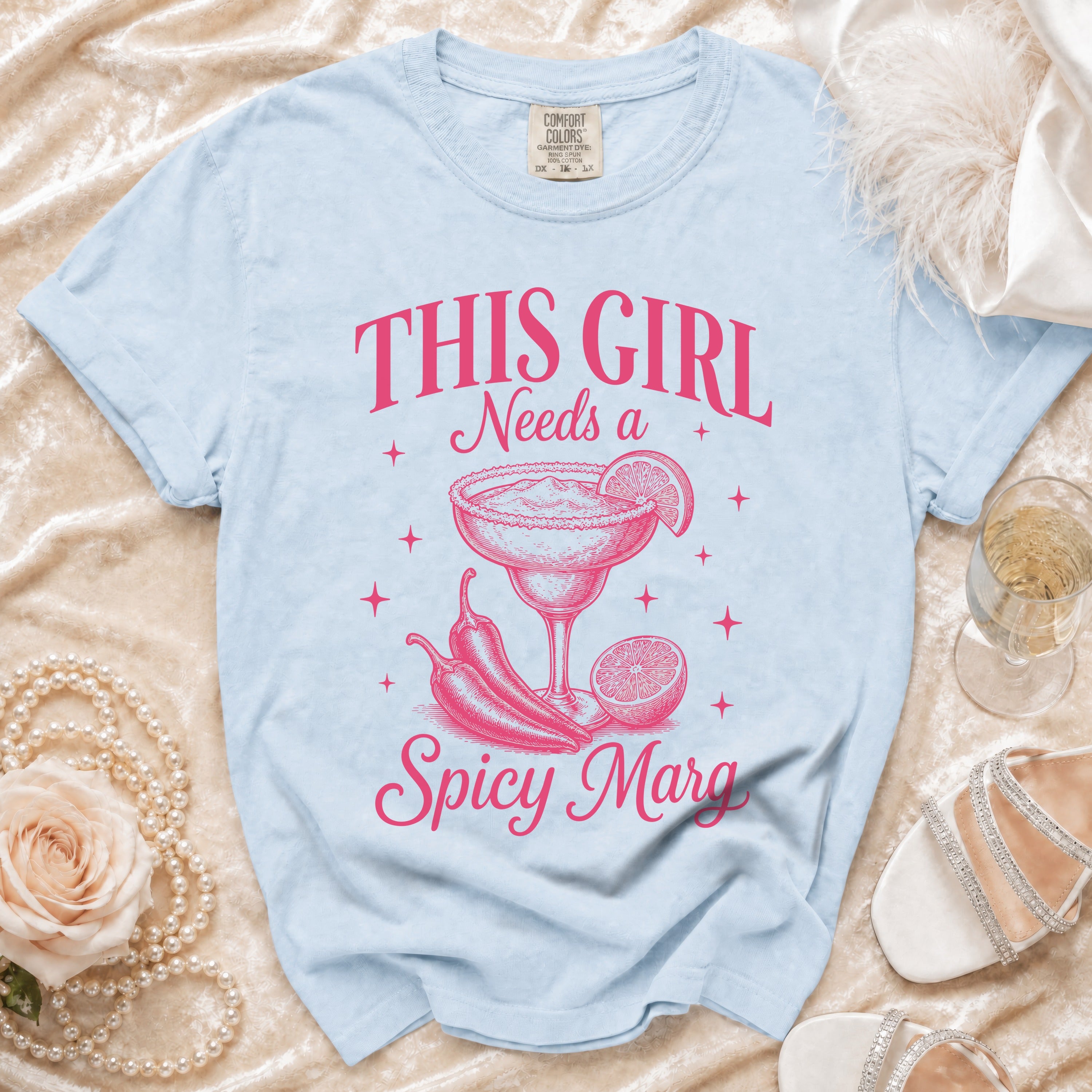Light blue t-shirt with pink graphic "THIS GIRL Needs a Spicy Marg" and margarita.