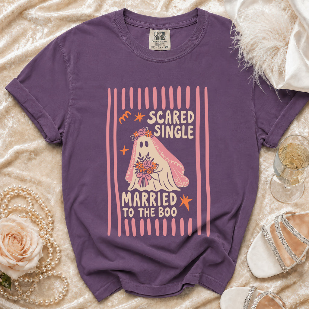 Purple t-shirt with ghost graphic saying "Scared Single Married to the Boo".