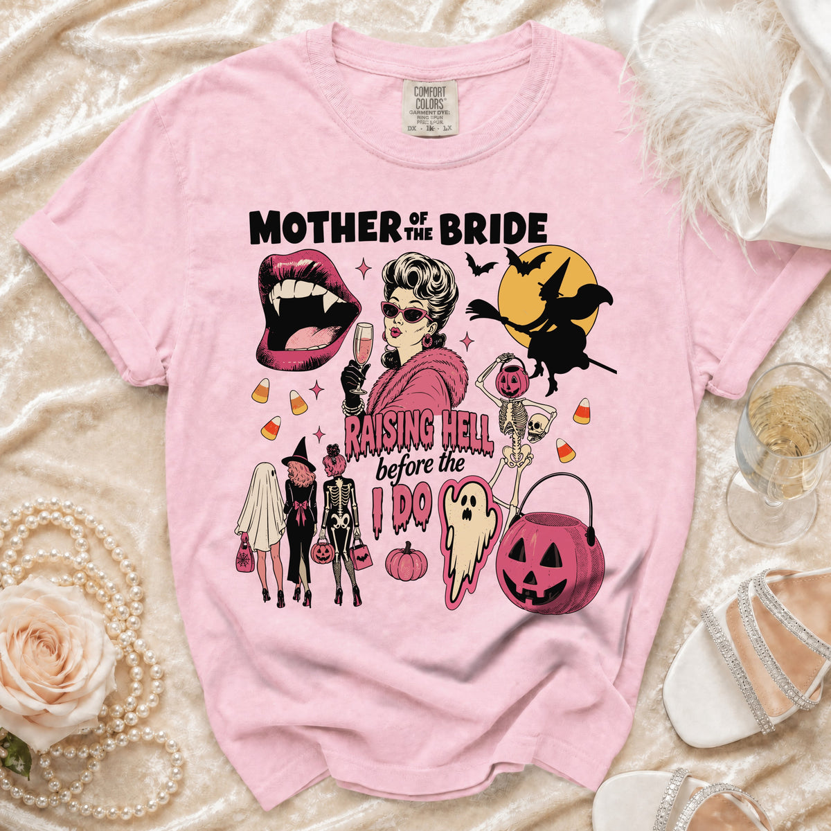 Pink t-shirt with "Mother of the Bride Raising Hell Before the I Do" Halloween graphic.