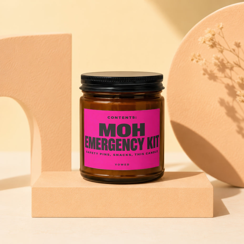 Brown candle labeled "MOH EMERGENCY KIT" on a pink label with "VOWED".