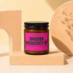 Brown candle labeled "MOH EMERGENCY KIT" on a pink label with "VOWED".