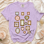 Lavender t-shirt with a collage of framed wedding-themed illustrations and text.