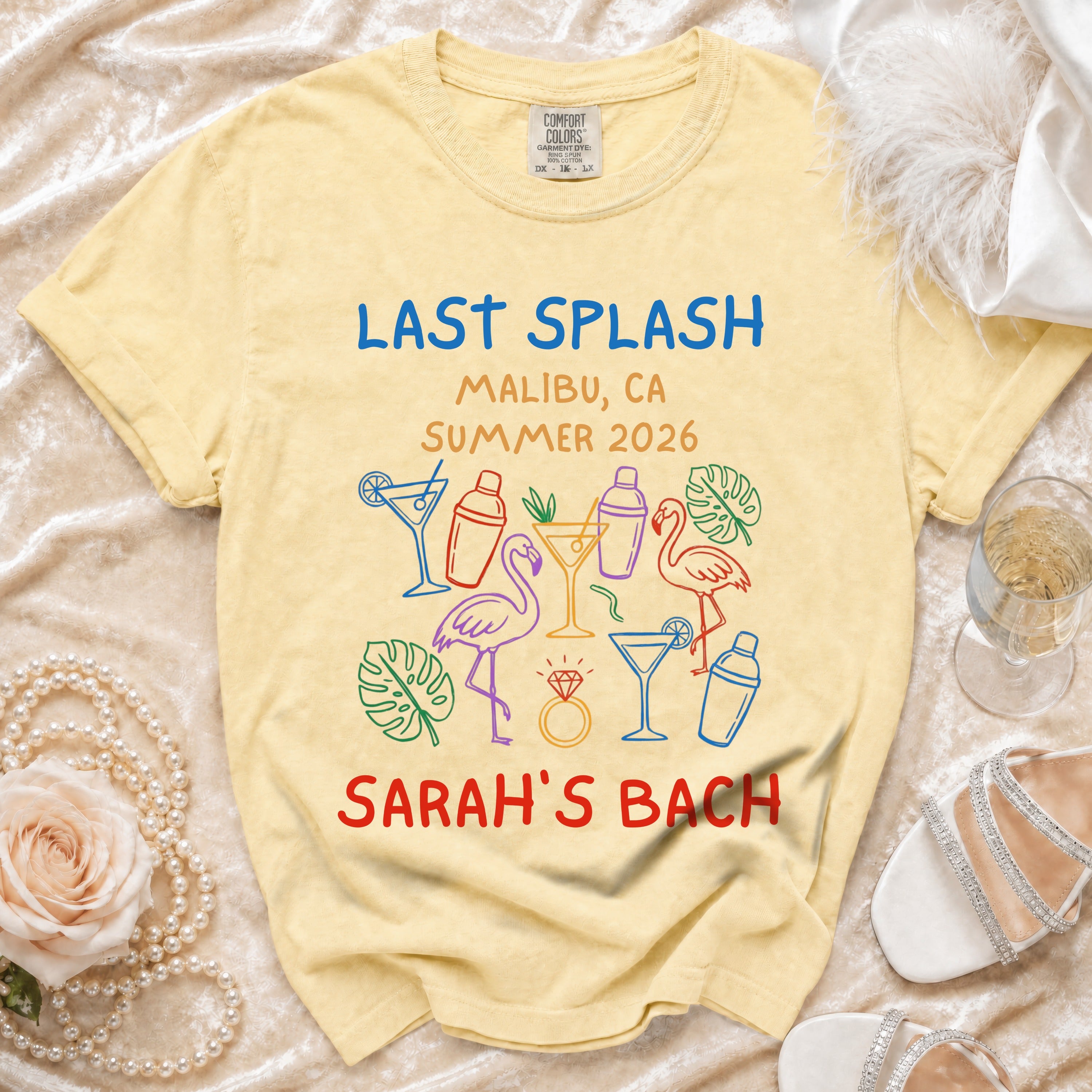 Yellow t-shirt with "Last Splash Malibu CA Summer 2026 Sarah's Bach" and colorful graphics.