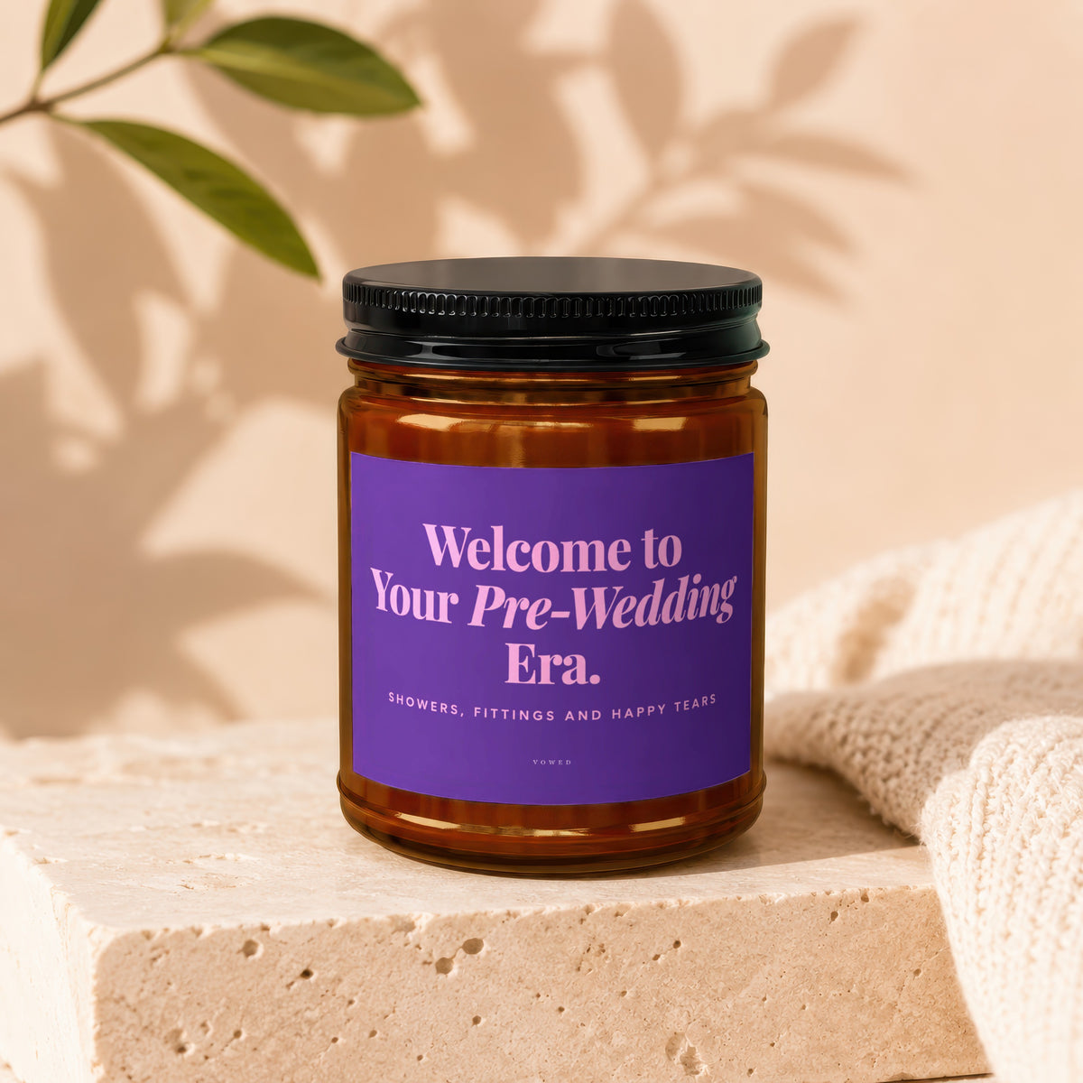 Candle with purple label reading "Welcome to Your Pre-Wedding Era. Showers, Fittings and Happy Tears."