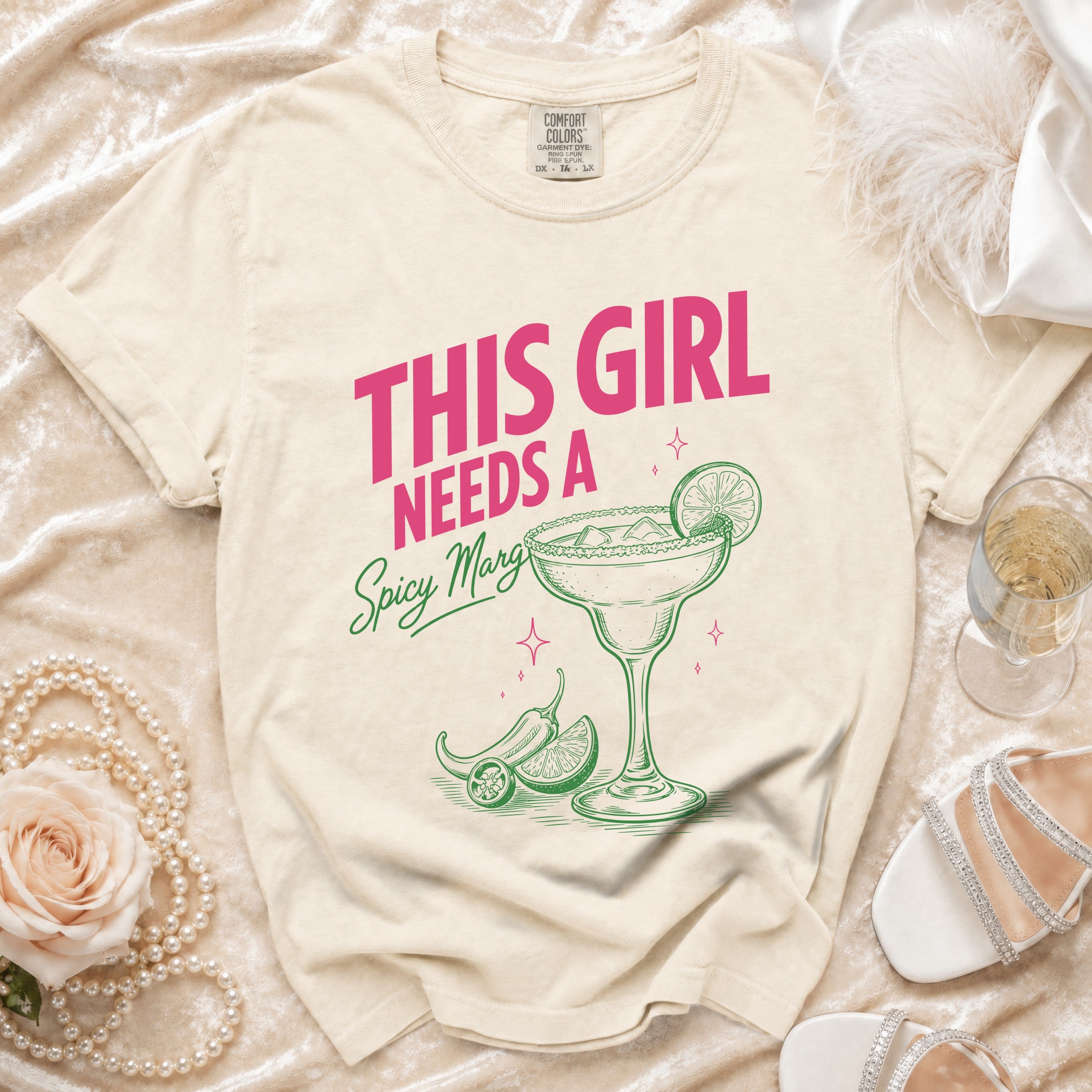 Cream t-shirt with pink text "THIS GIRL NEEDS A Spicy Margi".