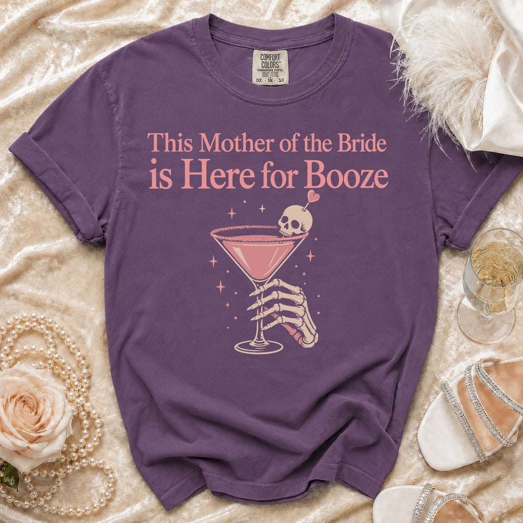 Purple t-shirt with "This Mother of the Bride is Here for Booze" text and skeleton hand holding a cocktail.