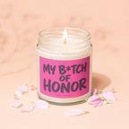 Candle with pink label reading "My B*tch of Honor" and "Vowed Candle Co."
