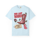 Light blue t-shirt with "Her Last Rodeo" text and a decorated cowboy boot.