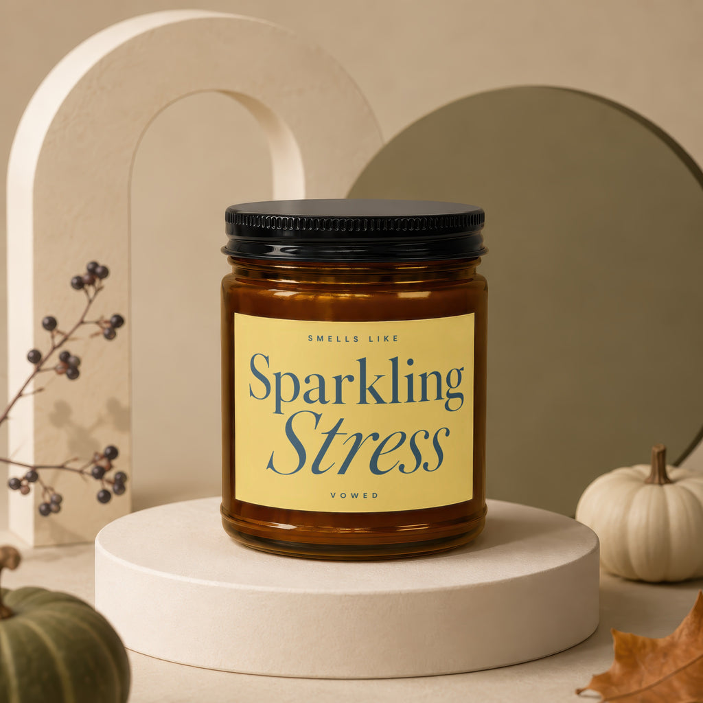 Brown glass candle with an amber hue on a display pedestal, labeled "Sparkling Stress."