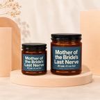 Two amber glass candles with blue labels reading "Mother of the Bride's Last Nerve".