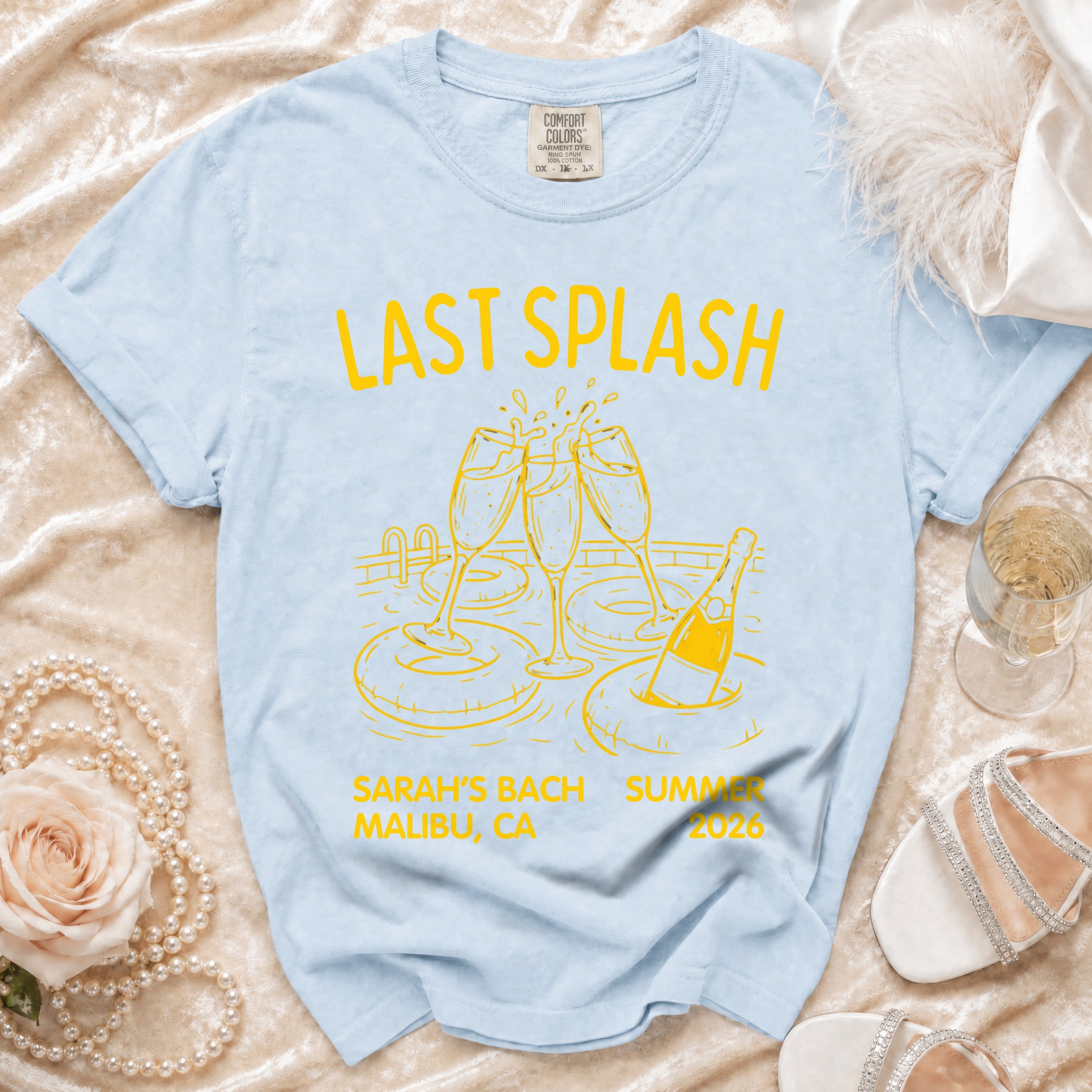 Light blue t-shirt with "LAST SPLASH SARAH'S BACH SUMMER MALIBU, CA 2026" text.