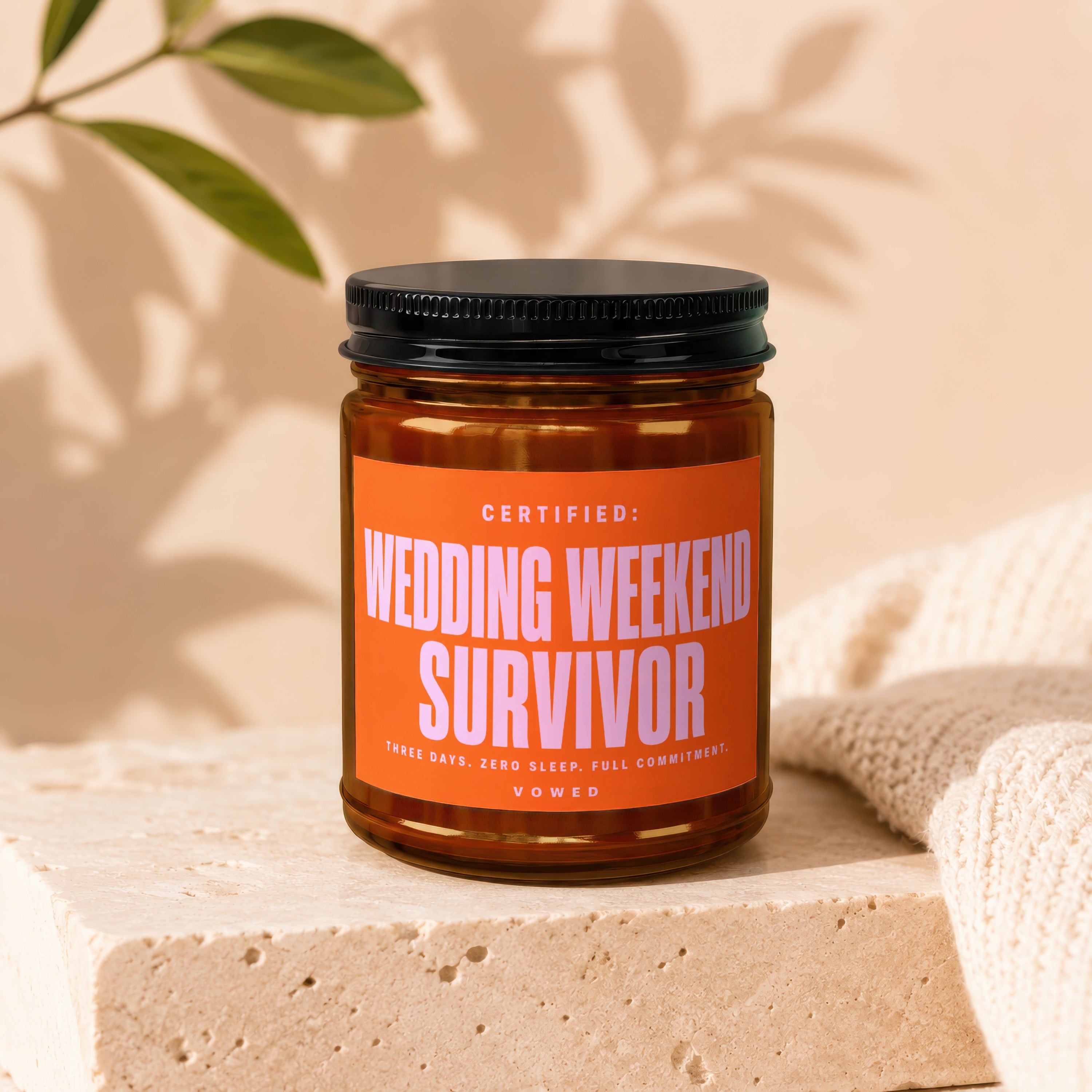 Candle labeled "Wedding Weekend Survivor" with text about three days, zero sleep, full commitment.