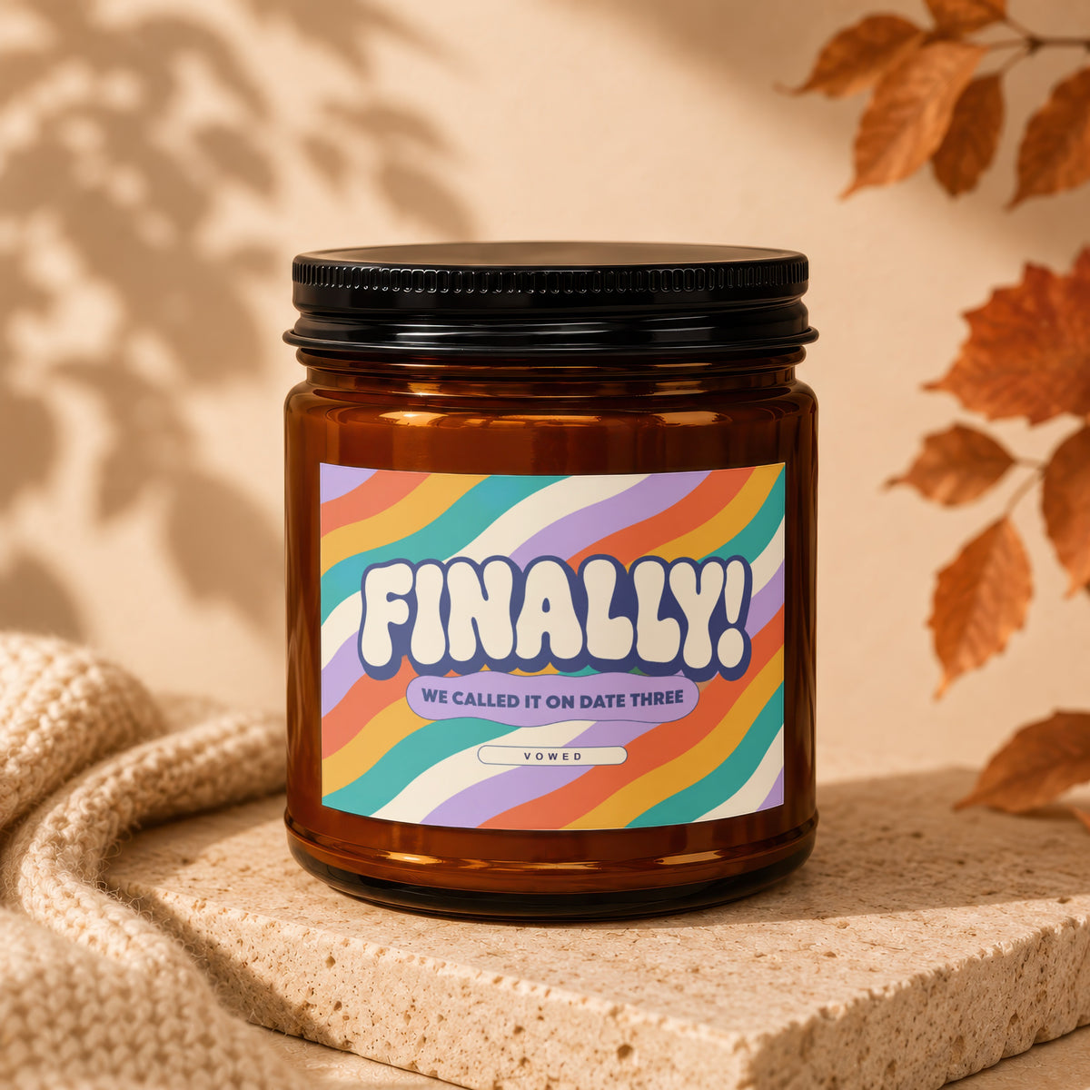 Amber glass candle with "FINALLY! WE CALLED IT ON DATE THREE VOWED" label.