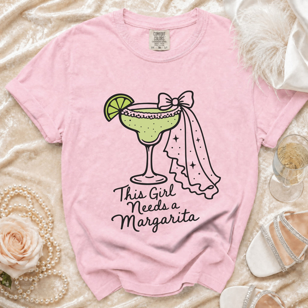 Pink t-shirt with "This Girl Needs a Margarita" text and margarita graphic.