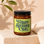 Amber jar with black lid, yellow label reads "Future Spouses Club, VOWED".