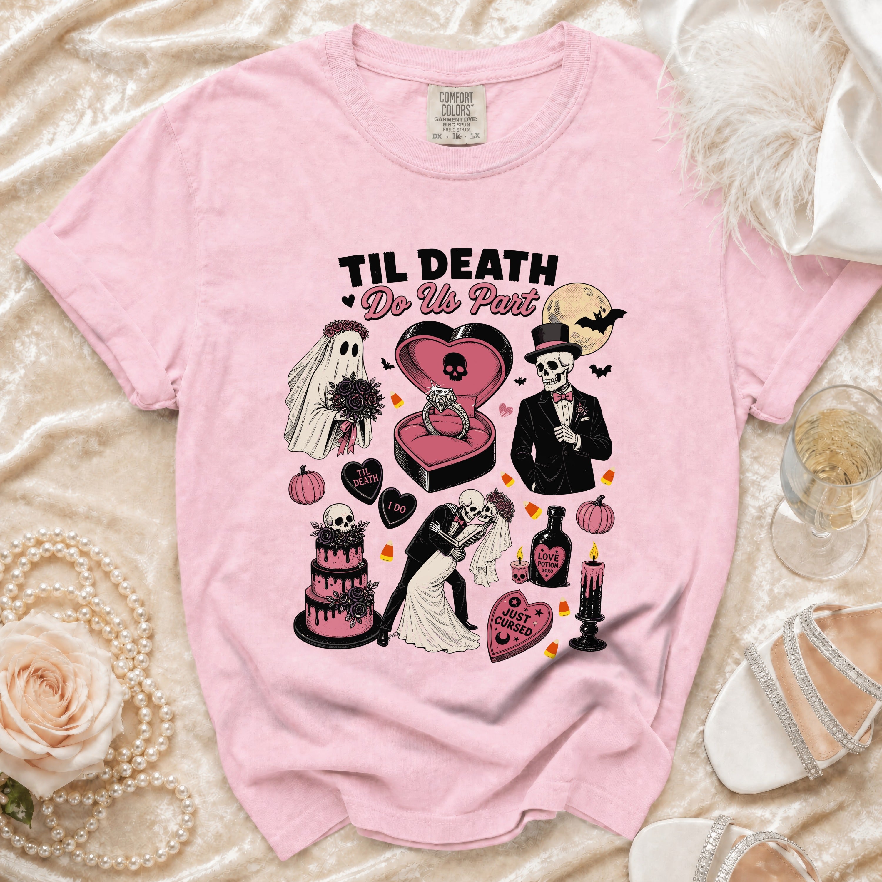 Pink t-shirt with "Til Death Do Us Part" graphic featuring skeletons, ghost, wedding cake.