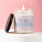 Jar candle with lid off, reads "To the happy couple, vowed" on pink label.