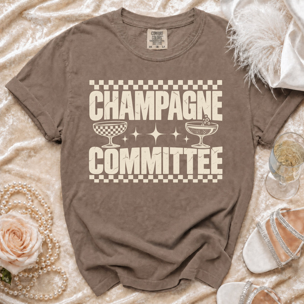 Brown t-shirt with "CHAMPAGNE COMMITTEE" text and champagne glasses graphic.