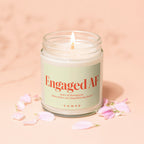 Lit candle with "Engaged AF" on label, notes of champagne, chaos, and planning board.