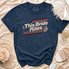 Navy t-shirt with "This Bride Bites" graphic, bat, and rose veil design.