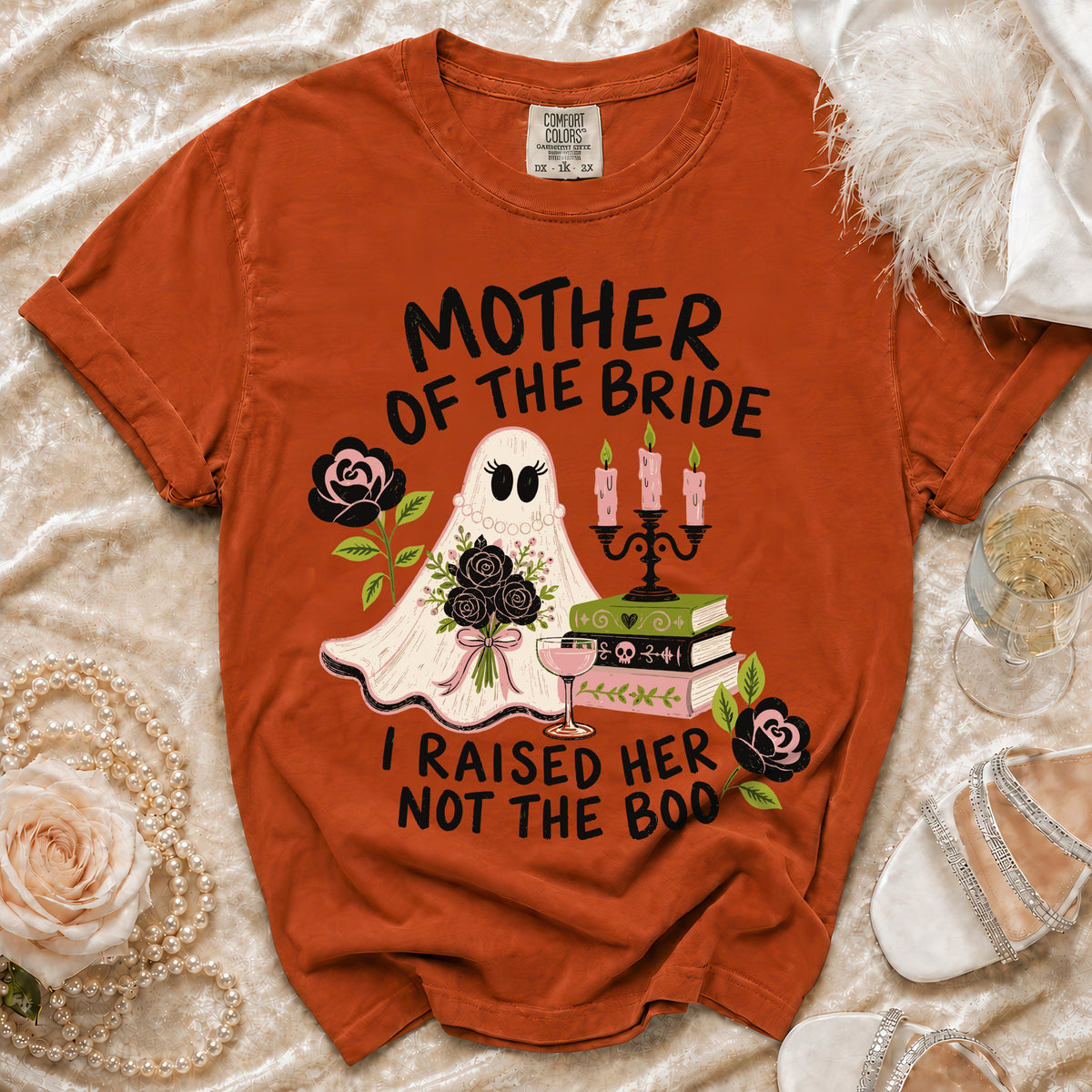 Orange t-shirt with ghost, flowers, books, and text "Mother of the Bride I Raised Her Not The Boo".