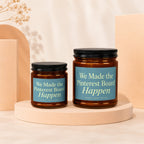 Two amber glass candles with blue labels read "We Made the Pinterest Board Happen".