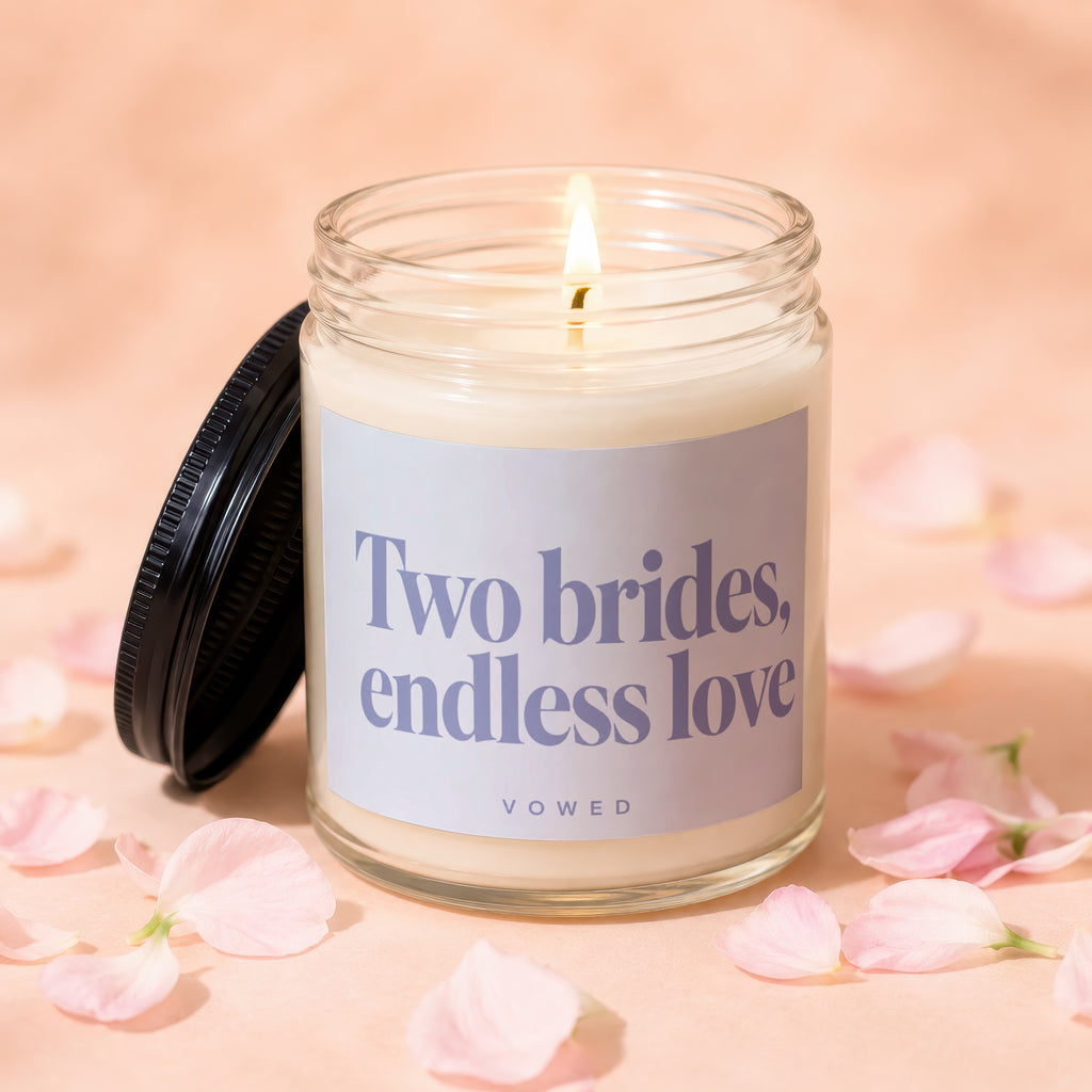 Lit candle in glass jar with lid nearby, petals scattered around.
