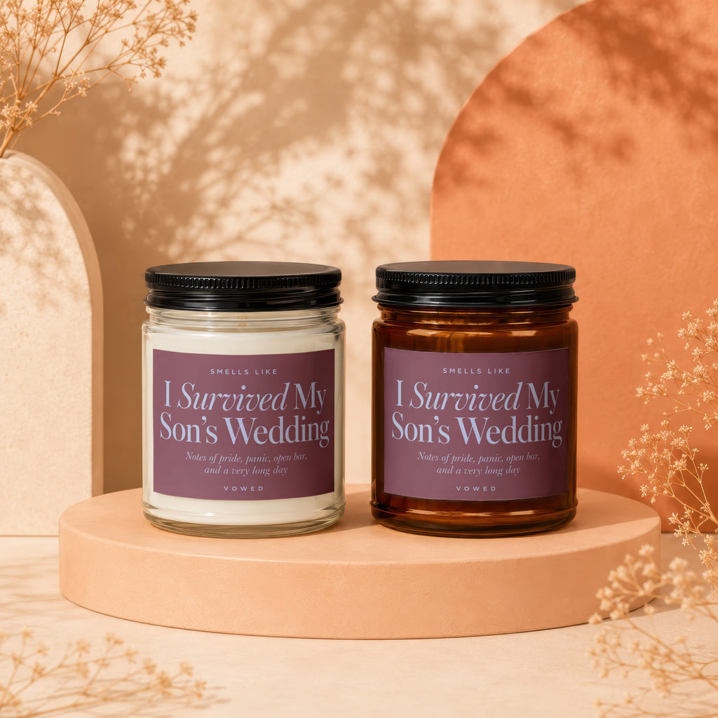 Two candles labeled "I Survived My Son's Wedding" with scent notes.