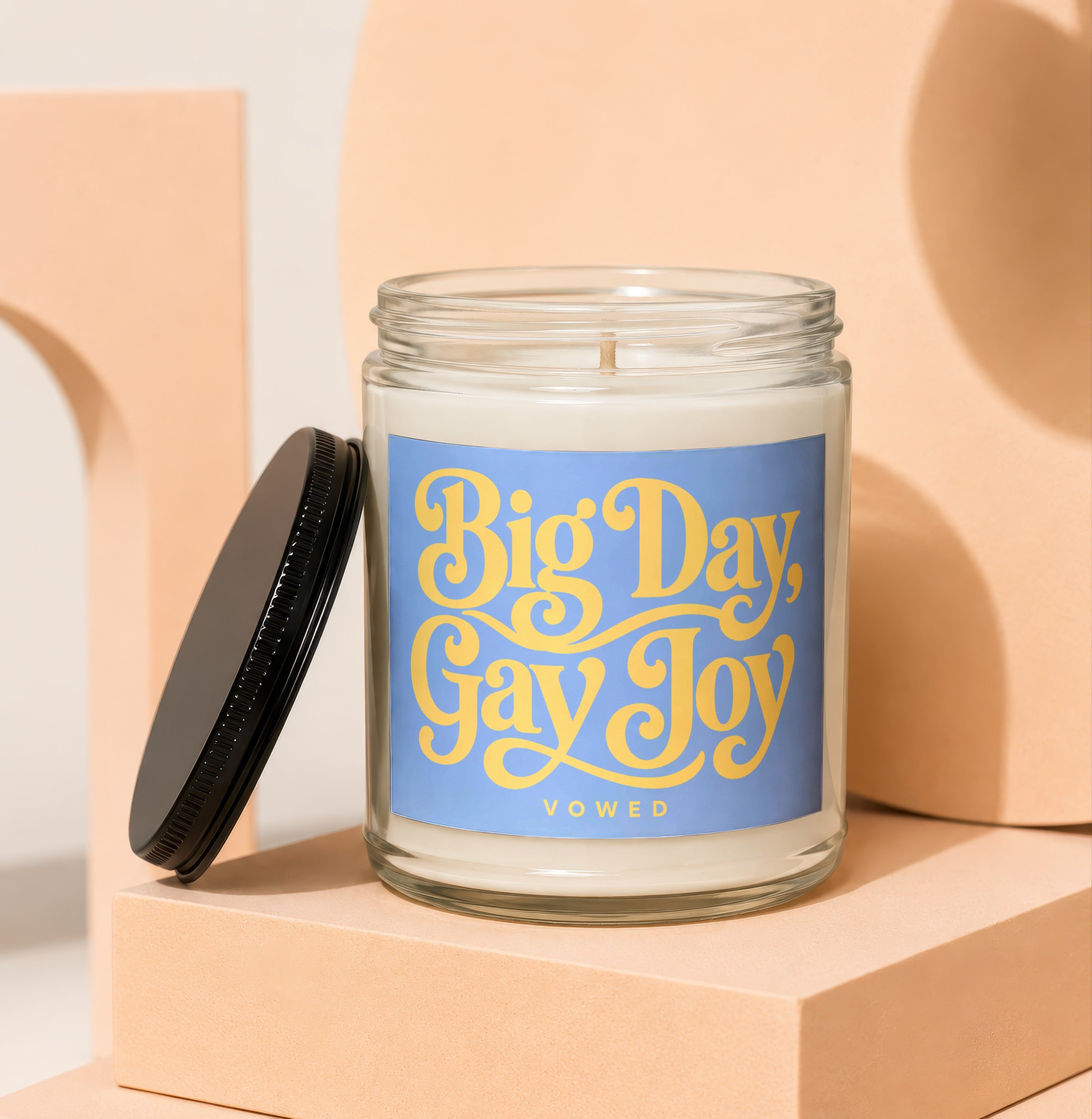 Glass candle with blue label that reads "Big Day, Gay Joy" and "VOWED".