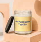 Glass candle with gold label that reads "Our Next Chapter, Together."