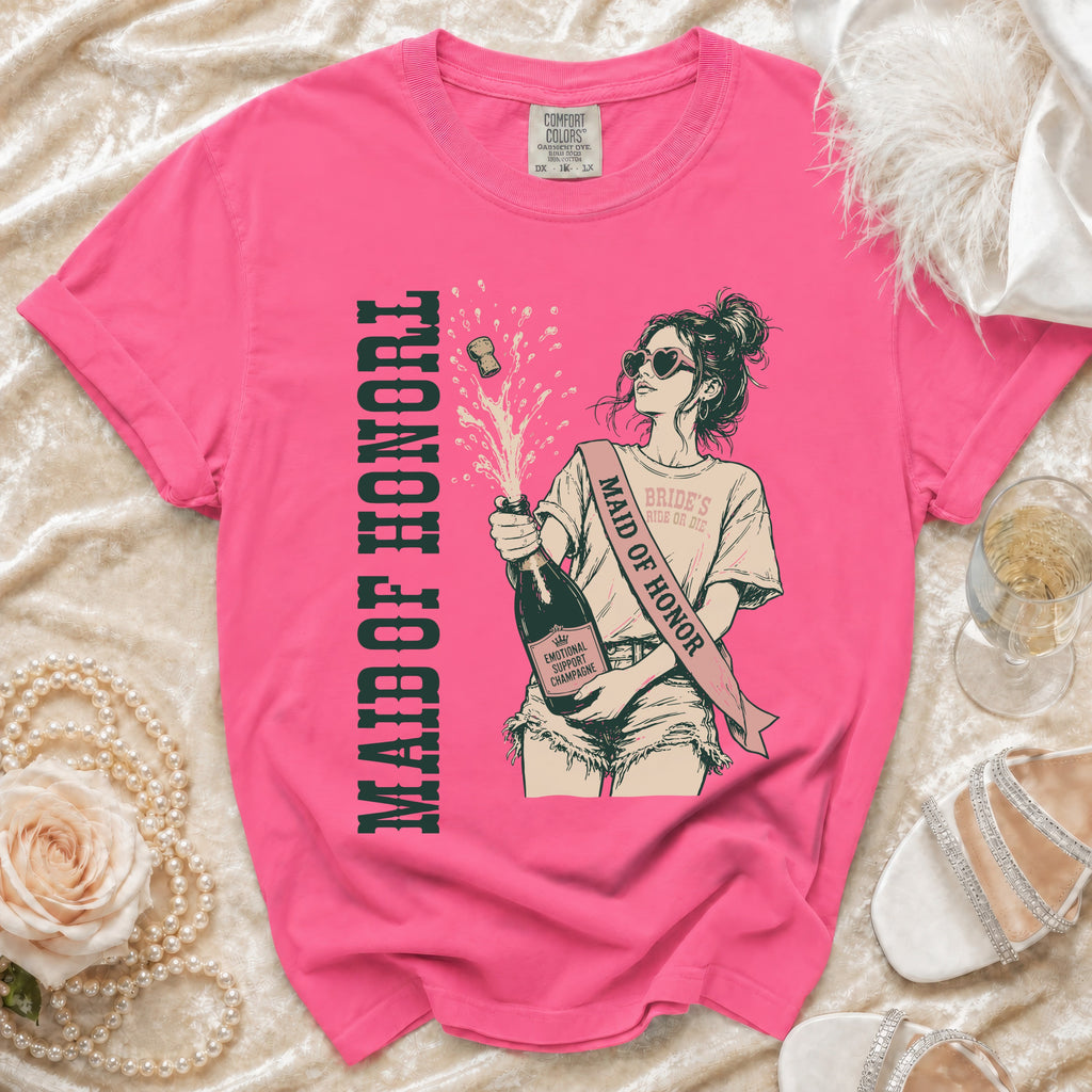 Pink t-shirt with graphic of a woman holding champagne, "Maid of Honor" text.