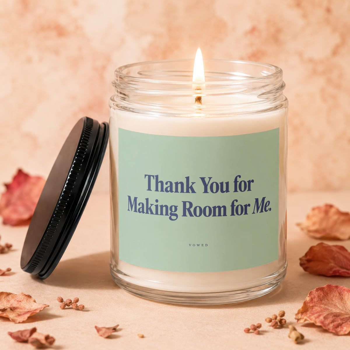 Lit candle in a glass jar with "Thank You for Making Room for Me" text.