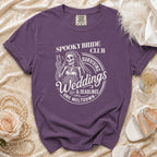 Purple t-shirt with skeleton bride graphic: "Spooky Bride Club Surviving Weddings & Deadlines One Meltdown".