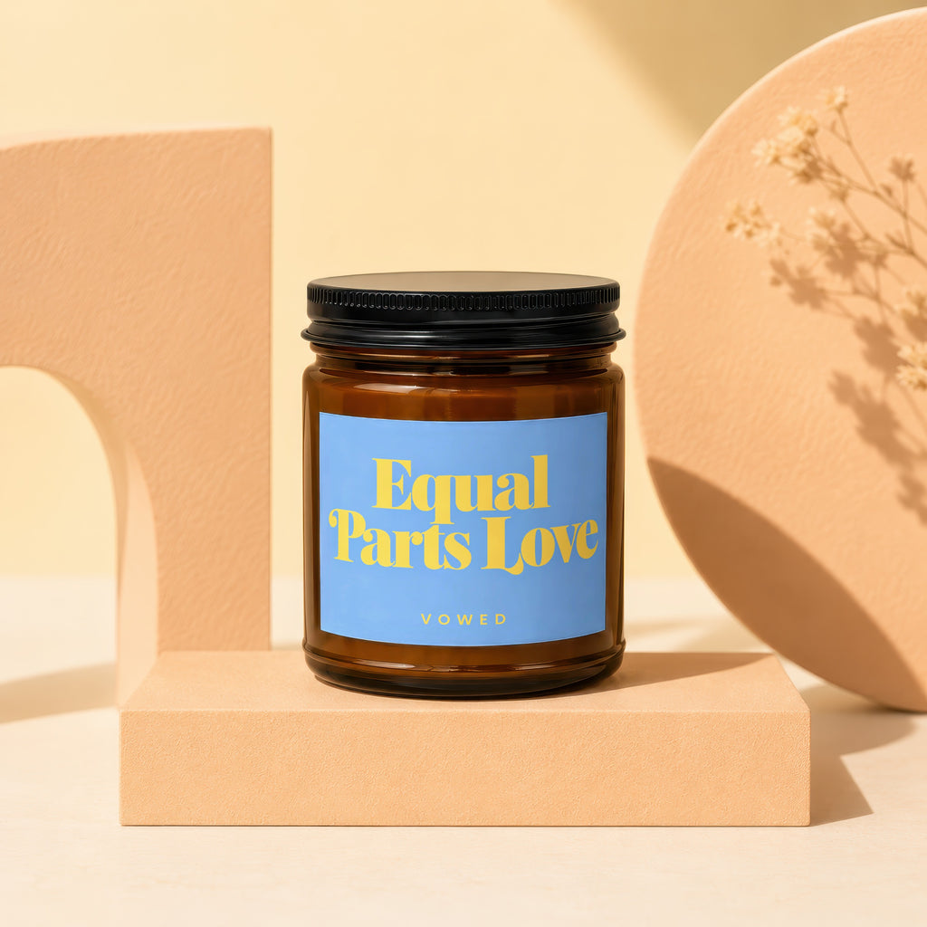 Candle with "Equal Parts Love" on blue label, Vowed branding.